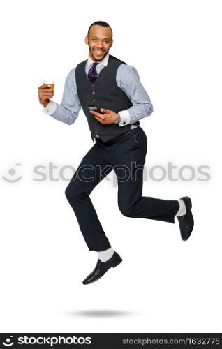 happy young african businessman jumping high and holding coffee to go and phone isolated on white background.. happy young african businessman jumping high and holding coffee to go and phone isolated on white background