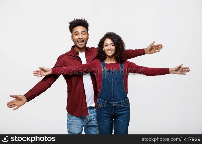 Happy young African couple dressed casually having fun together. Happy young African couple dressed casually having fun together.