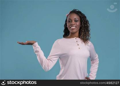Happy Young African Woman Isolated Presenting On Blue Background