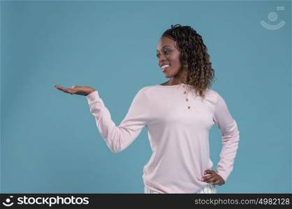 Happy Young African Woman Isolated Presenting On Blue Background
