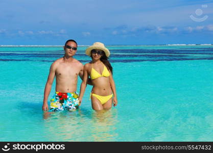 happy young asian couple enjoying summer and have on beautiful white sand beach