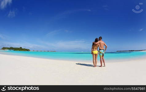 happy young asian couple enjoying summer and have on beautiful white sand beach