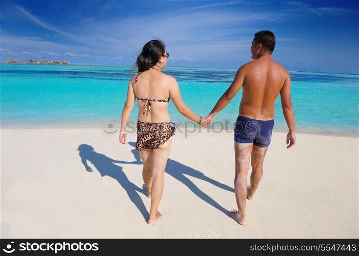 happy young asian couple have fun and romantic time at summer on beautiful white sand beach