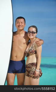 happy young asian couple have fun and romantic time at summer on beautiful white sand beach