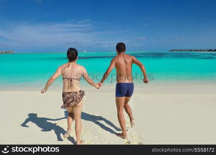 happy young asian couple have fun and romantic time at summer on beautiful white sand beach