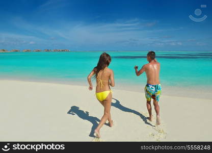 happy young asian couple have fun and romantic time at summer on beautiful white sand beach