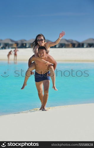 happy young asian couple have fun and romantic time at summer on beautiful white sand beach