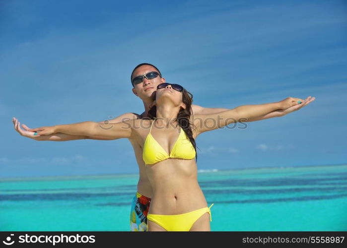 happy young asian couple have fun and romantic time at summer on beautiful white sand beach