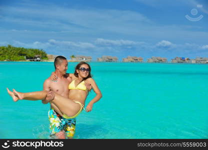 happy young asian couple have fun and romantic time at summer on beautiful white sand beach