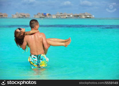 happy young asian couple have fun and romantic time at summer on beautiful white sand beach