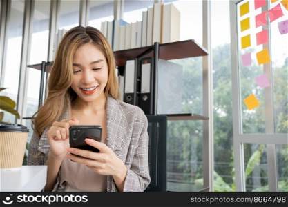 Happy young Asian women startup entrepreneur happy and excited smiling after getting message for success sign business contact, happy girl on workplace. Distance learning online education and work.