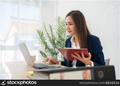 Happy young Asian women startup entrepreneur happy and excited smiling after getting email for success sign business contact, happy girl on the workplace. Distance learning online education and work.