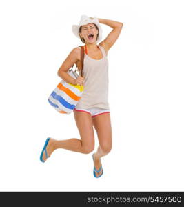 Happy young beach woman in hat jumping