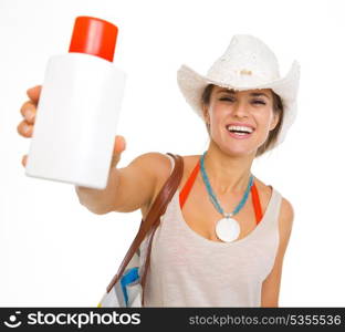 Happy young beach woman in hat showing sun block creme