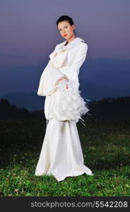 happy young beautiful bride after wedding ceremony event have fun on meadow in fashionable wedding dress