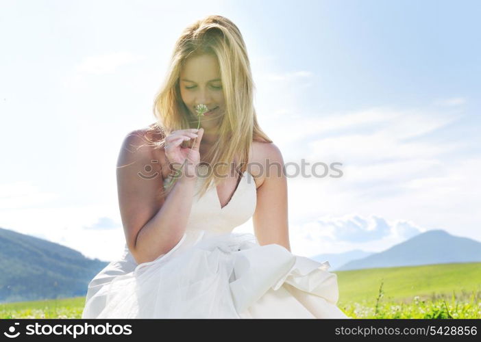 happy young beautiful bride after wedding ceremony event have fun outdoor on meadow at sunset