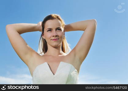 happy young beautiful bride after wedding ceremony event have fun outdoor on meadow at sunset