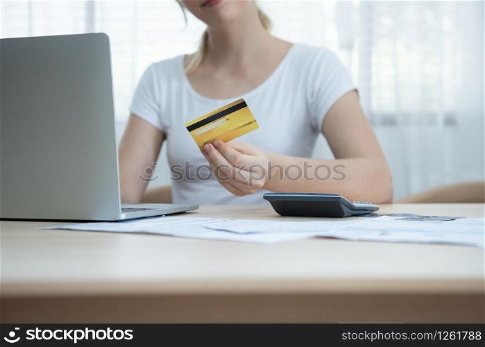 Happy young beautiful caucasian woman using credit card register payments online shopping and customer service network connection market, using internet e-commerce technology on laptop.