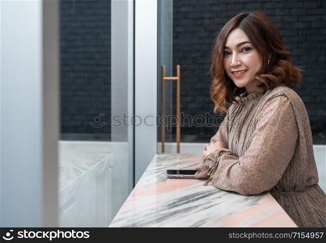happy young beautiful woman at window