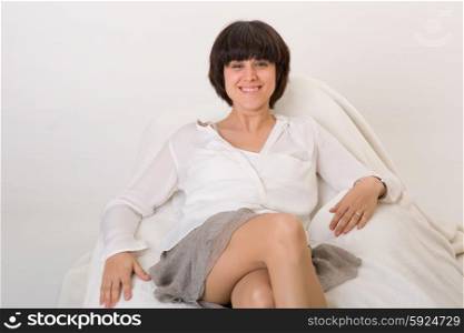 happy young beautiful woman relaxing on sofa at home