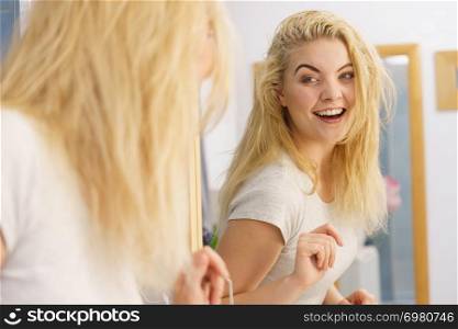 Happy young blonde woman after waking up in bathroom. Female feeling great fresh and clean.. Happy fresh blonde woman in bathroom