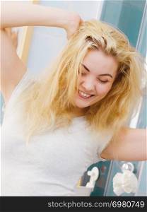Happy young blonde woman after waking up in bathroom. Female feeling great fresh and clean.. Happy fresh blonde woman in bathroom