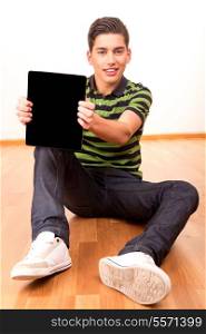 Happy young boy presenting your product in a tablet computer