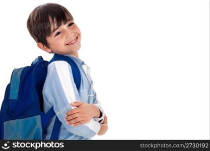 Happy young boy ready for school with his bag on isolated white background
