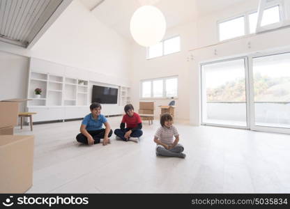 happy young boys having fun on the floor in a new modern home