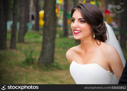 Happy young bride at forest