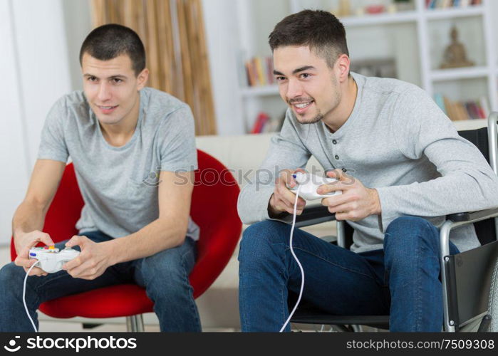 happy young brothers playing video games