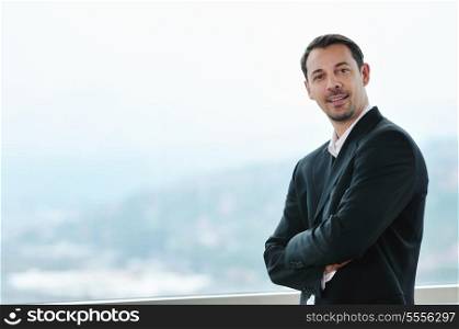 happy young business man portrait in suit with isolated blured background