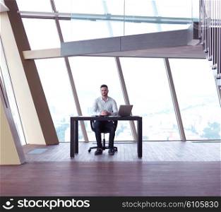 happy young business man work and relax at modern bright office interior, hipster with beard at workplace