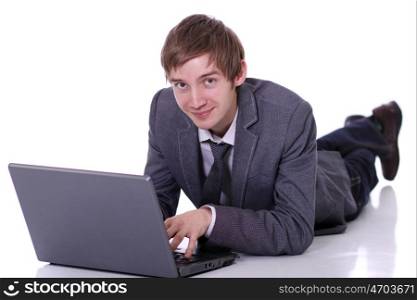 Happy young business man working on a laptop, isolated on white background