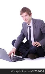 Happy young business man working on a laptop, isolated on white background