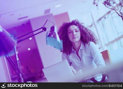 happy young business woman with curly hairstyle in the modern office