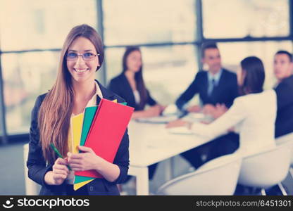 happy young business woman with her staff, people group in background at modern bright office indoors