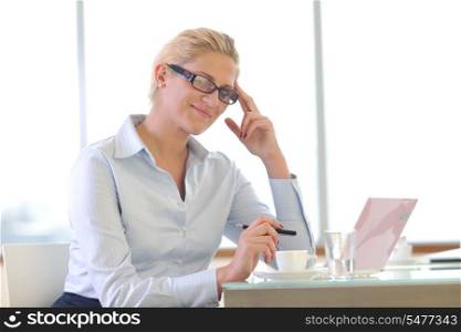 happy young business woman working on laptop computer at group team meeting at modern office