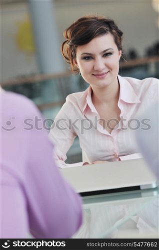 happy young business woman working on laptop computer at group team meeting at modern office