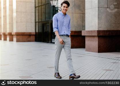 Happy Young Businessman in Casual wear Walking in the City. Lifestyle of Modern People. Looking at the Camera. Full Length