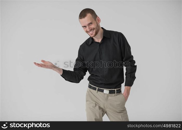 Happy Young Businessman Presenting Over White Background