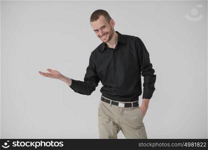 Happy Young Businessman Presenting Over White Background