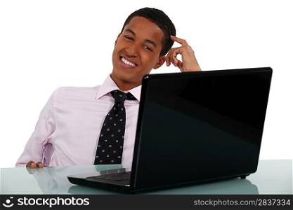 Happy young businessman scratching head