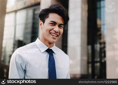 Happy Young Businessman Standing with a Big Smile in the City. Looking at Camera. Closeup Shot