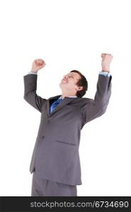 Happy young businessman with his hands up on white background