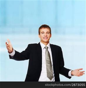 Happy young businessman with open hands