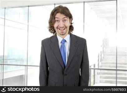 happy young businessman with silly face at the office