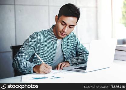 Happy Young Businessman Working on Computer Laptop in Office