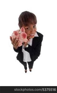 Happy young businesswoman with piggy-bank
