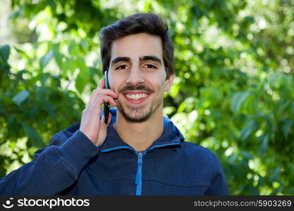 happy young casual man on the phone outdoor